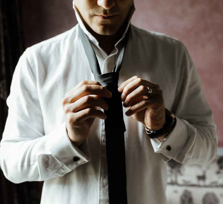 Groom gets ready during wedding morning