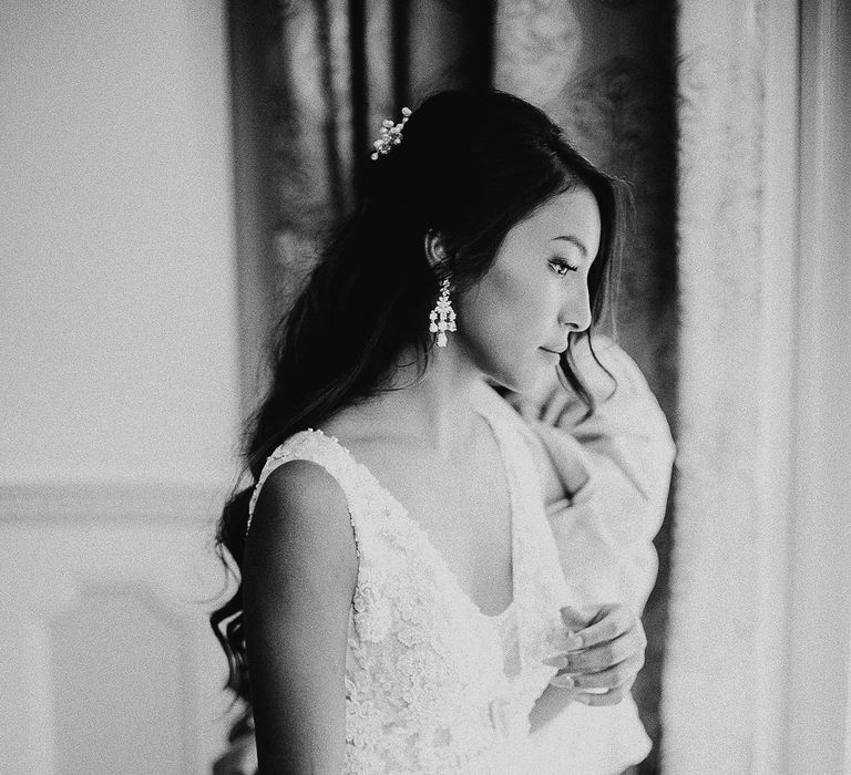 Bride gets ready on the morning of her wedding in black & white photo