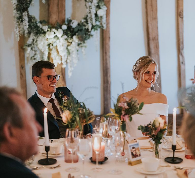 Bride & groom laugh during reception 