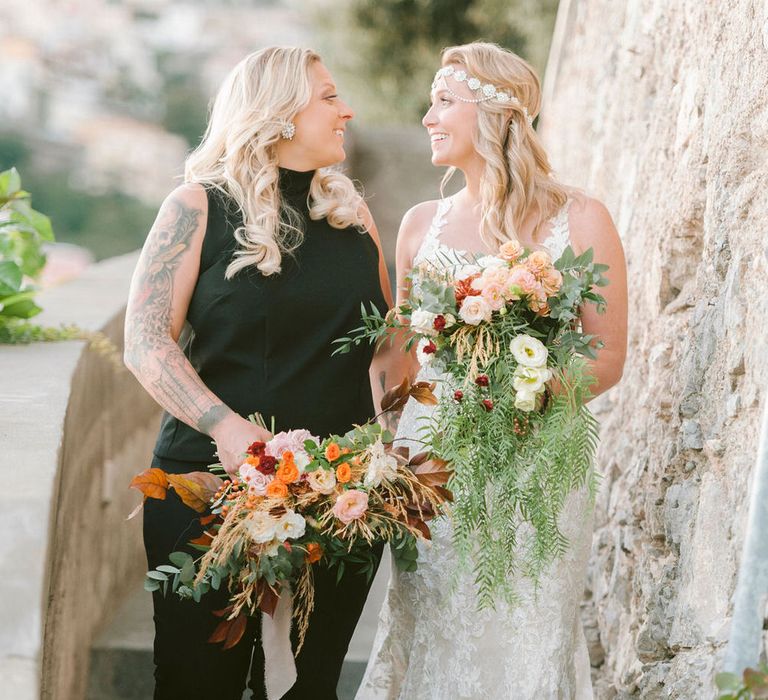 The brides walking through the grounds of Hotel Marincanto after their wedding ceremony