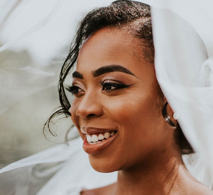 Black bridal makeup with winged eye liner, defined eyebrows and shimmering eyeshadow 