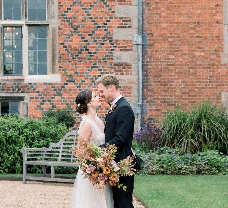 Classic wedding at Dorfold Hall with groom in tuxedo and monk shoes and bride in a romantic tulle and lace wedding dress