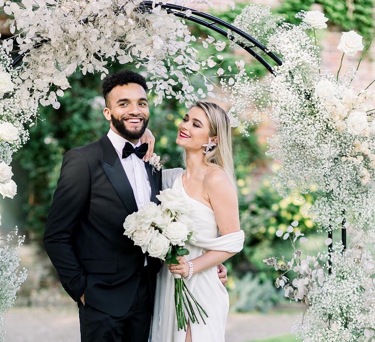 Summer wedding inspiration at Garthmyl Hall wedding venue with black-tie suit and wrap wedding dress