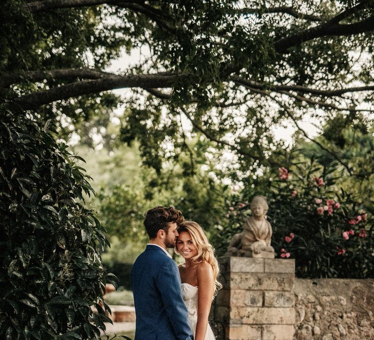 Bride and groom share a moment in the rustic grounds at Finca Biniagual