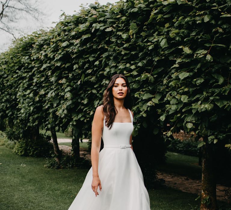 Bride in a princess wedding dress with full skirt, fitted bodice and thin straps from the new Suzanne Neville Nova 2022 bridal collection