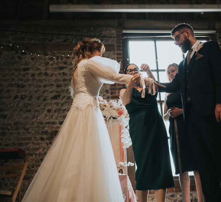 Bride & groom during handfasting ceremony at the Charleston House