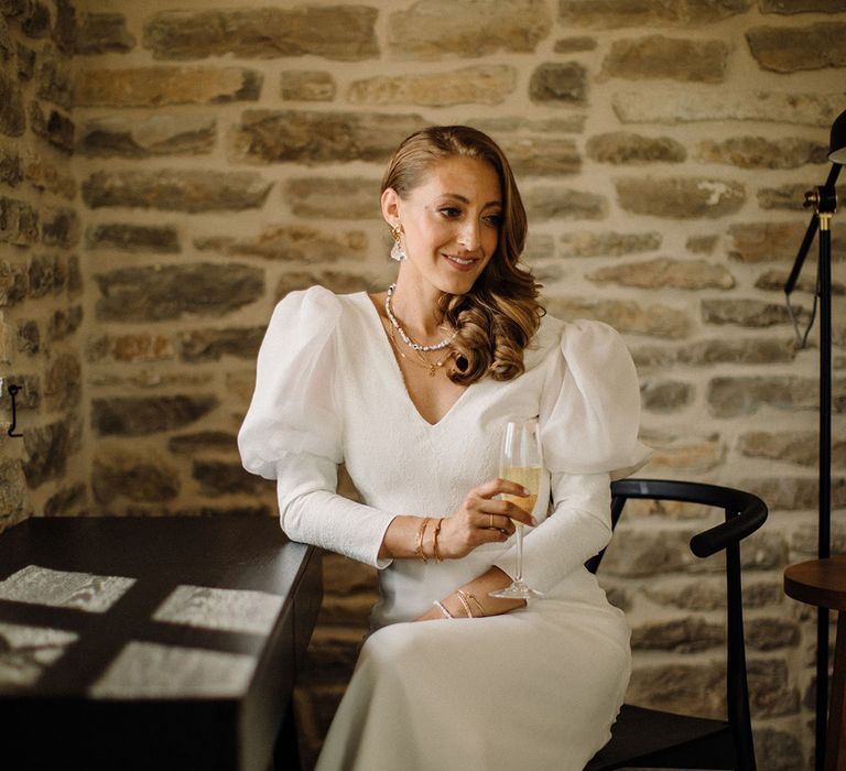 Bride sits down and wears puff sleeve wedding gown with sweetheart neckline 