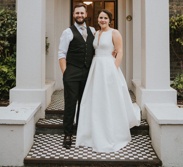 Bride in Jesus Peiro wedding dress with groom outside Georgian town house Norwich wedding