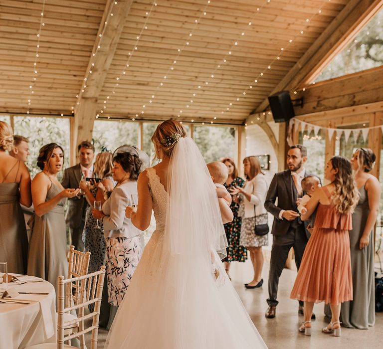 Bride at Chycara wedding venue with veil in pinned updo