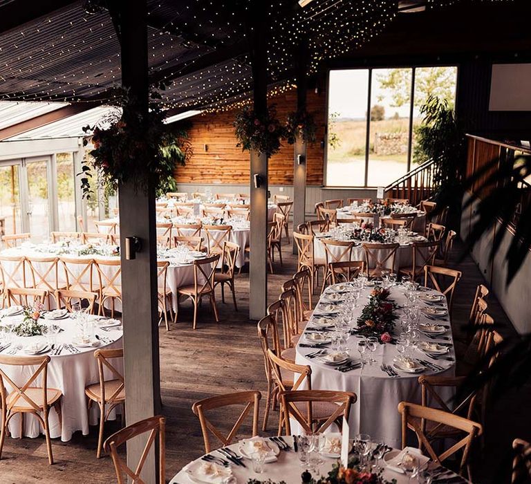 Stone Barn Cotswolds wedding with fairy light ceiling decor 