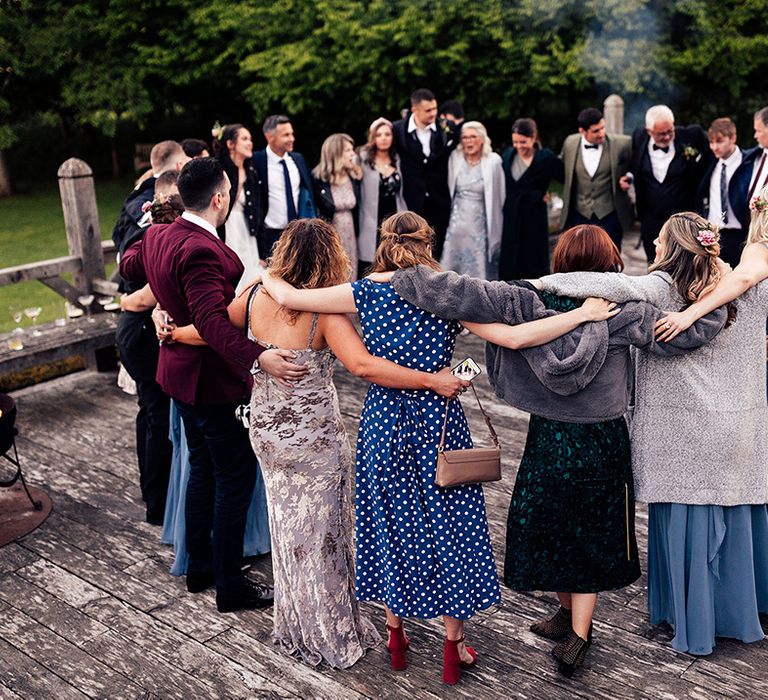 Wedding guests dance together at intimate spring celebration