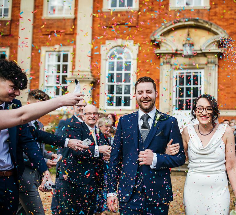 Bride & groom walk arm in arm with one another on their wedding day