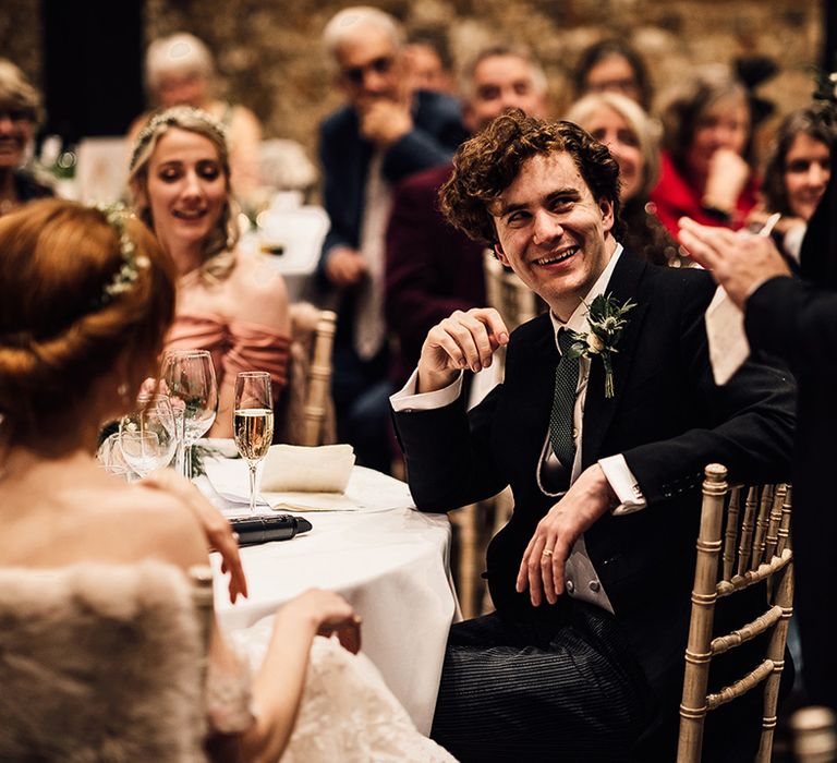 Bride and groom enjoy wedding speeches