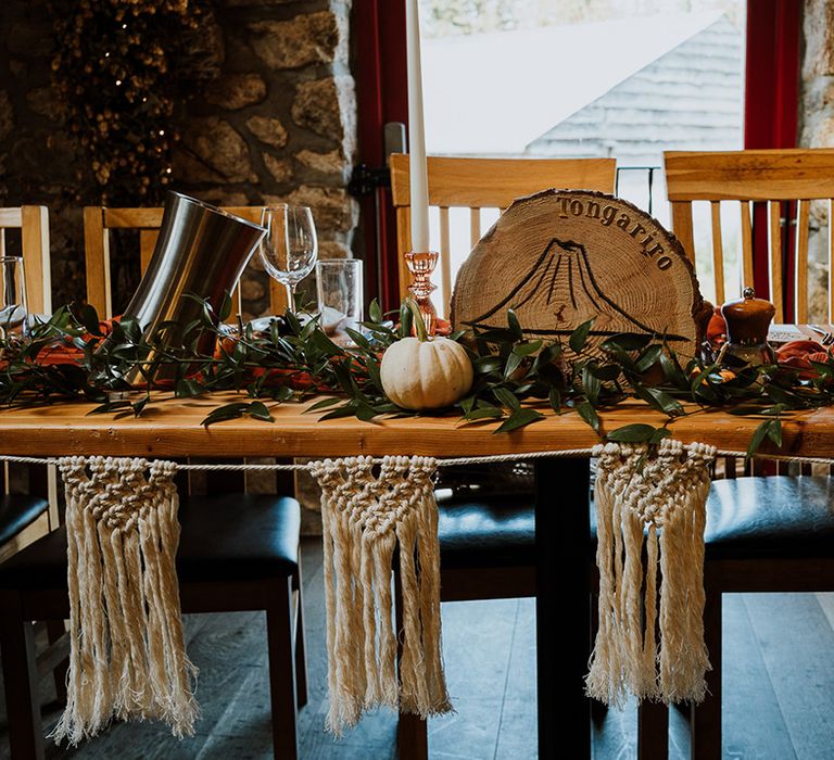 Wooden rustic table complete with pumpkin decor and macrame bunting