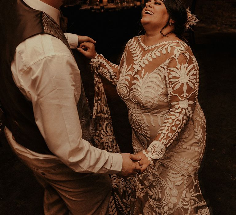 Groom in a waistcoat dancing with his Indian bride in a boho lace Rue de Seine wedding dress 