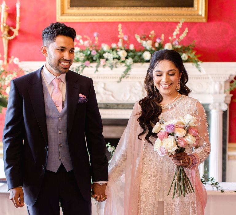 Groom looks lovingly at his bride on their wedding day