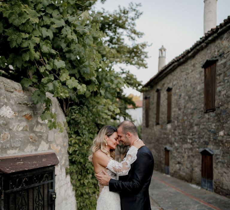 Bride & groom embrace outdoors on their wedding day in Greece 