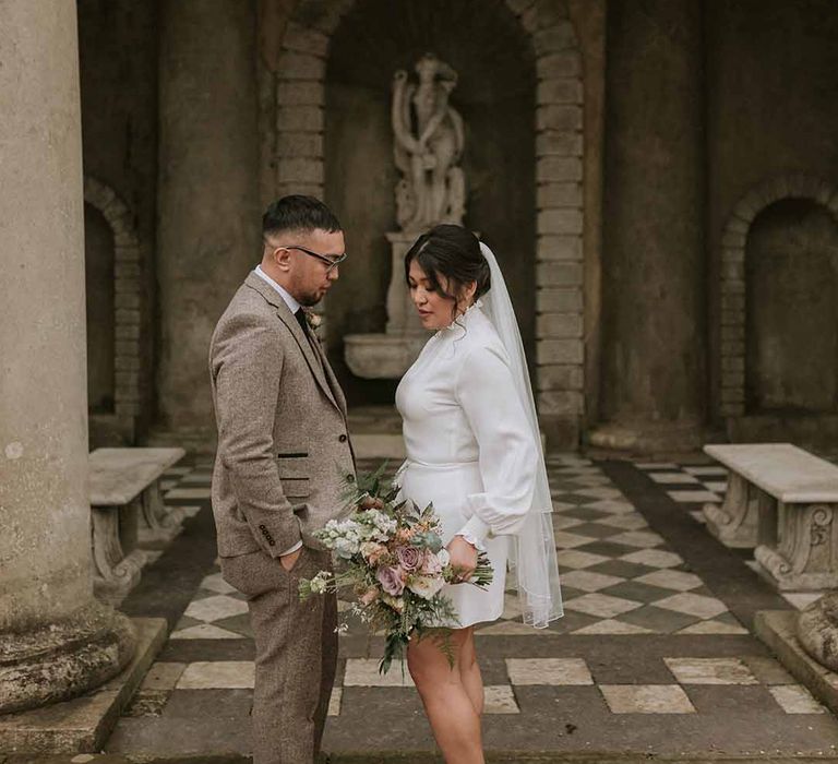 Groom and bride in short Vanessa Cocchiaro wedding dress 