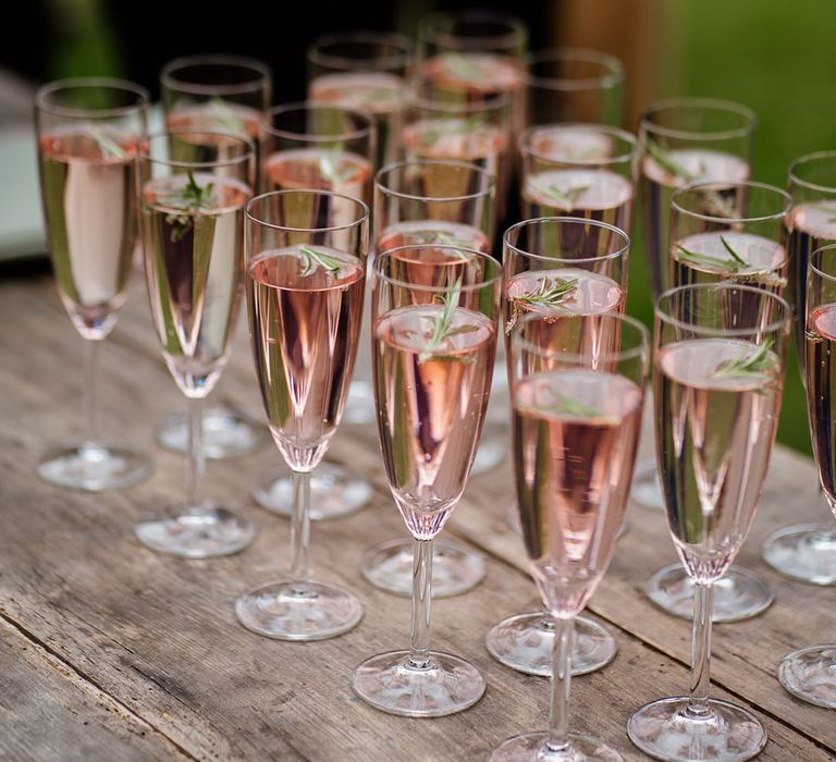 Champagne glasses full of drinks for wedding guests 