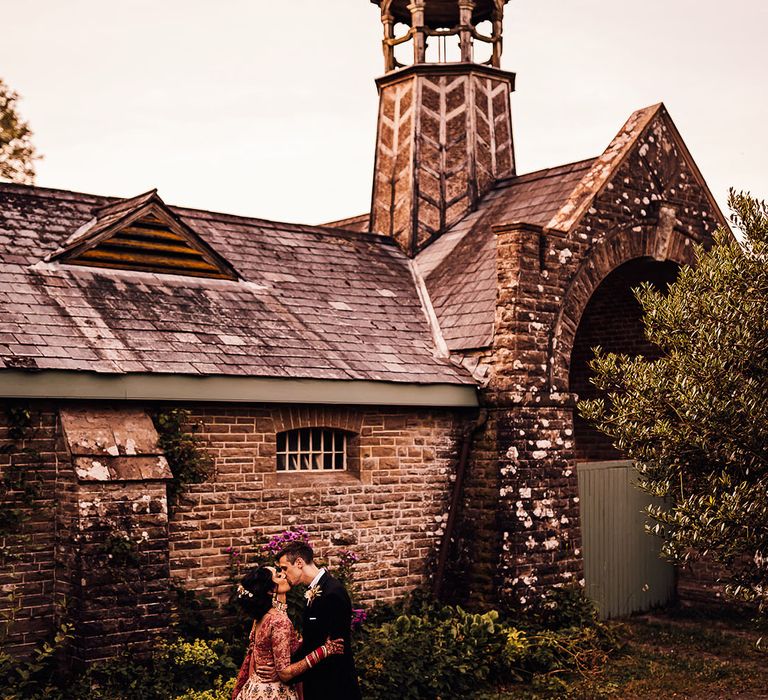 Bride & groom stand outside Bredenbury Court Barns after wedding ceremony