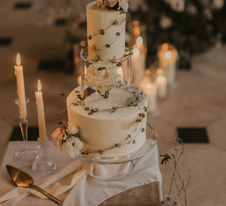 Traditional white wedding cake with a white rose decorative layer for a Christmas winter wedding 