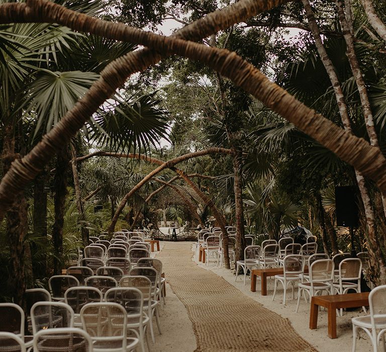 Outdoor wedding ceremony in Tulum surrounded by trees and foliage 