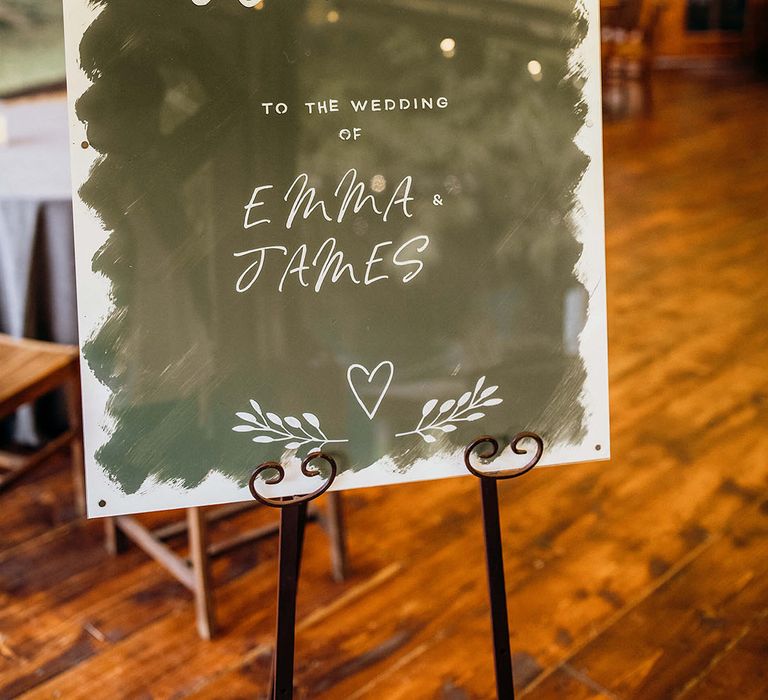 Modern styled wedding sign on metal easel for barn wedding ceremony 