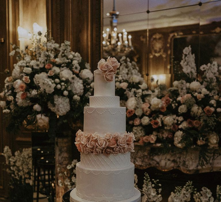 Six tier white iced luxe wedding cake with pink rose iced decorations 