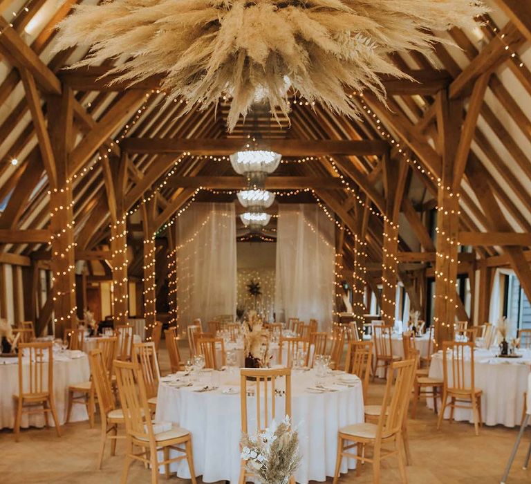 rustic barn wedding reception with pampas grass installation at The Old Barn Kent 