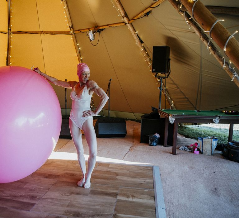 Large pink balloon and wedding singer in wedding tipi for evening wedding entertainment