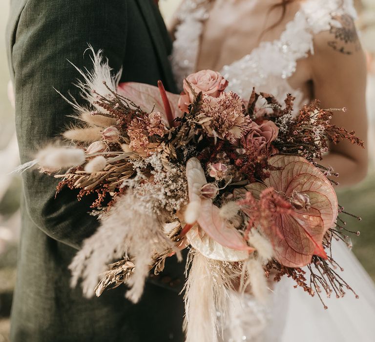 neutral and red dried and fresh flower wedding bouquet with pampas grass 