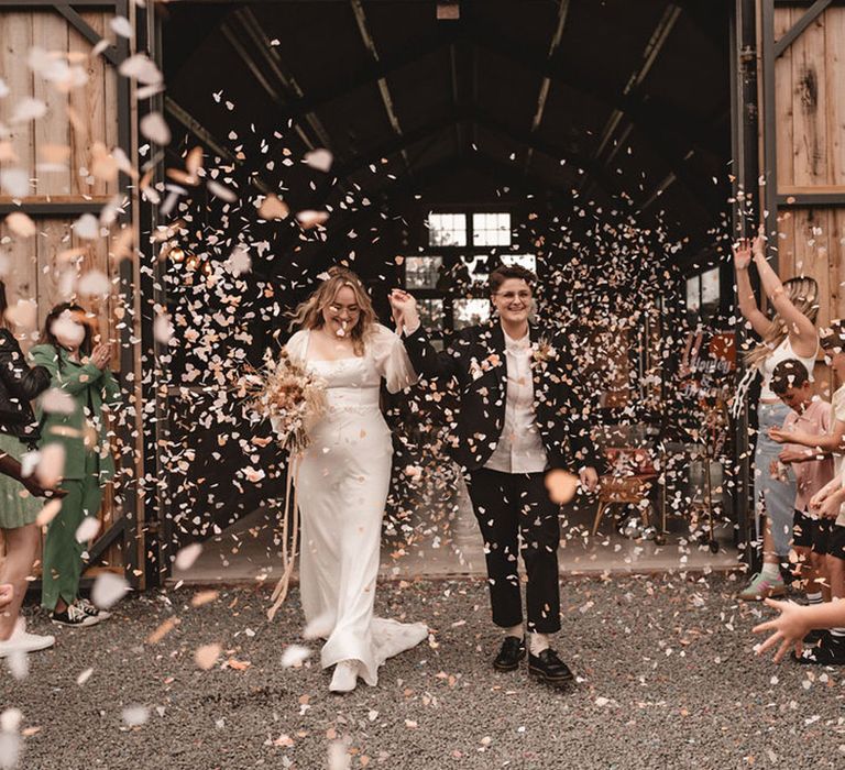 Confetti exit for brides at lesbian wedding with retro theme 