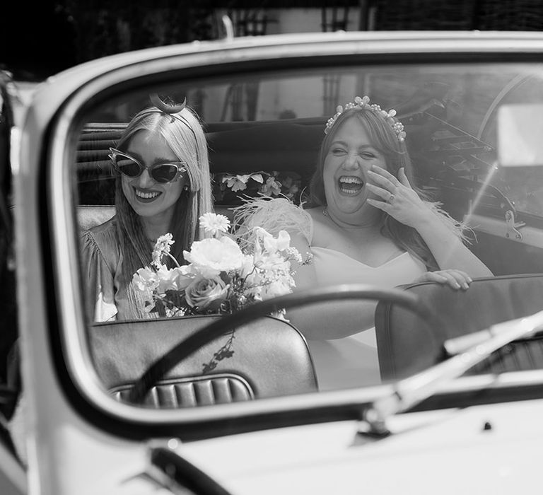 Bride and moon maiden ride in the wedding car to the wedding venue together 