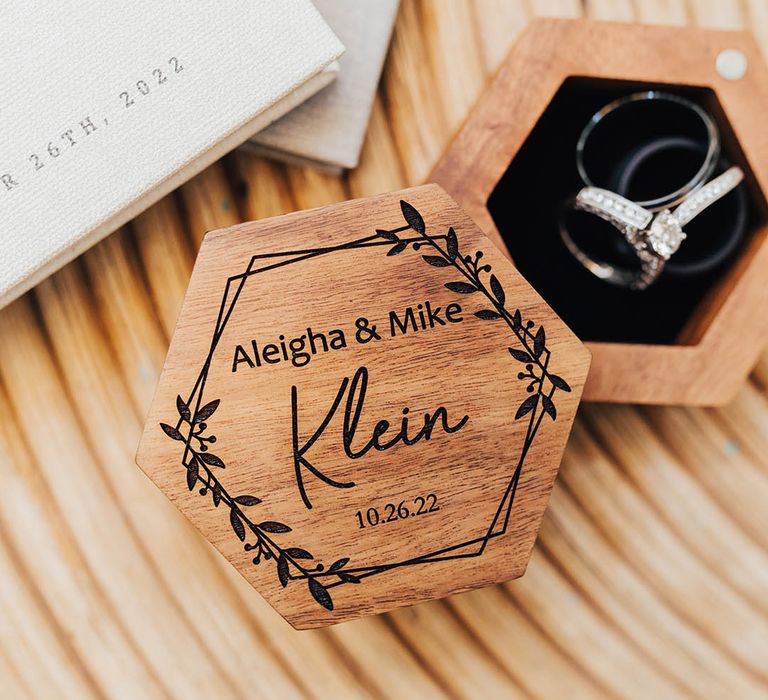 Personalised wooden custom ring box with the bride and groom's wedding bands inside 