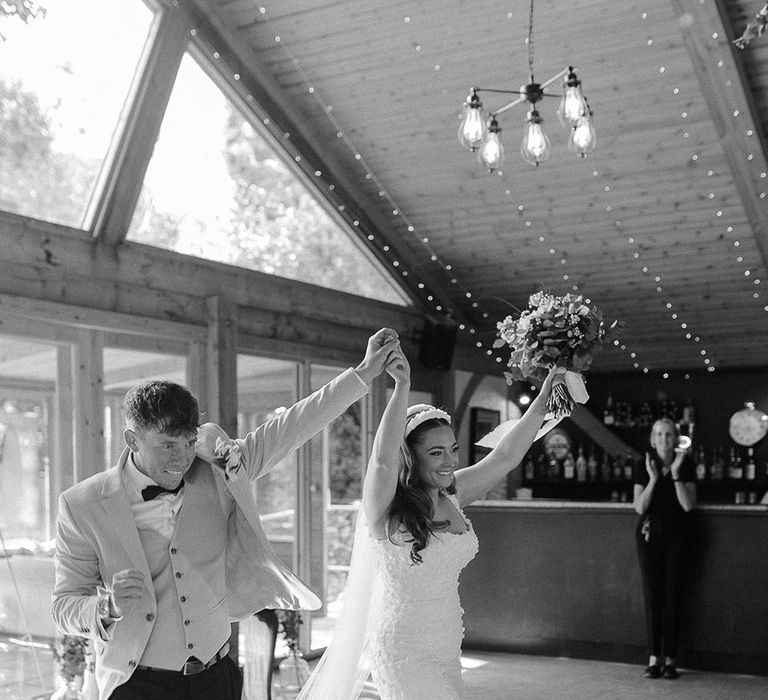 The bride and groom enter their wedding breakfast together at Chycara wedding in Cornwall with rustic luxe theme 