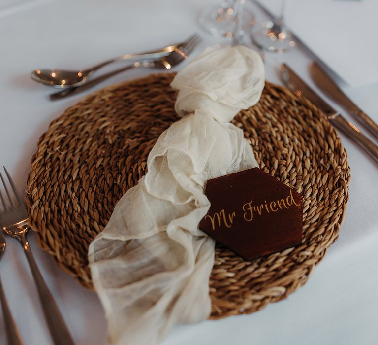 Wicker place mat with sheer napkin and custom made wedding place name for the autumnal wedding 