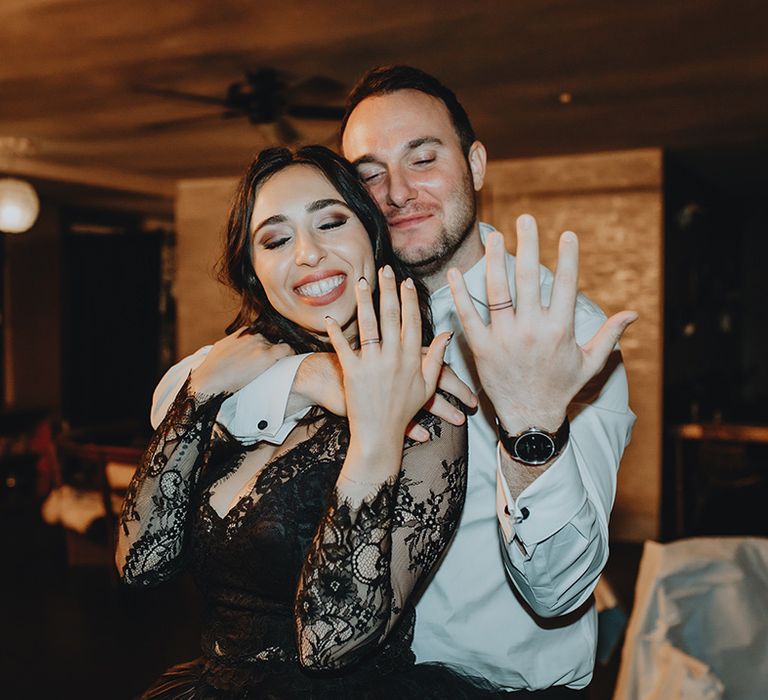 Bride and groom show off their matching wedding band tattoos in place of the traditional wedding band 