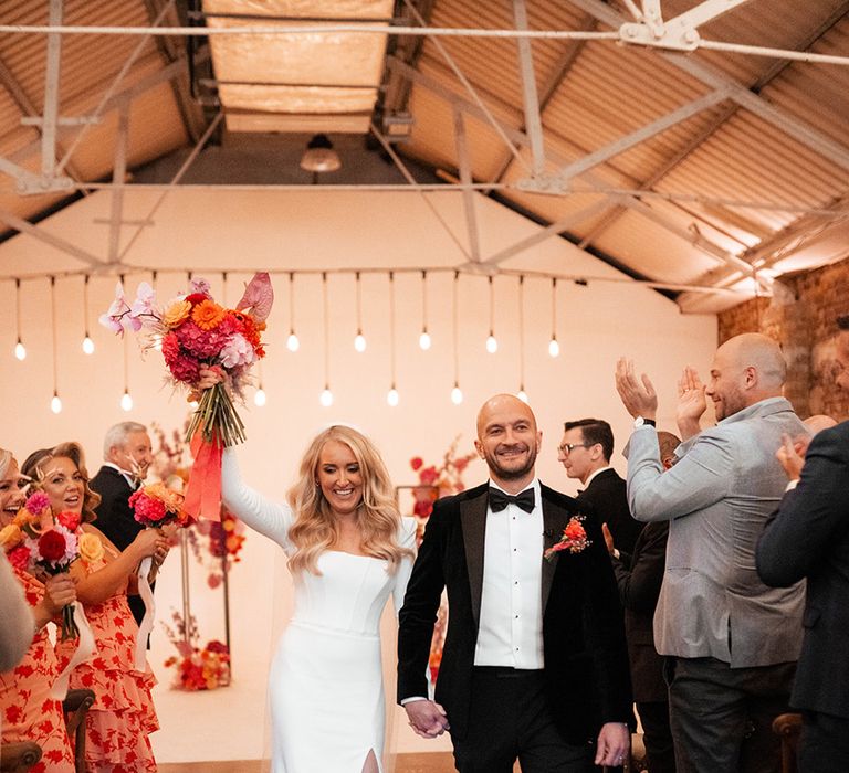 Shoreditch Studios wedding with the bride and groom walking back down the aisle as a married couple 