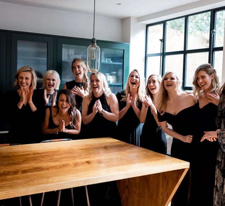 Bridesmaids see the bride for the first time in her Halfpenny London wedding dress