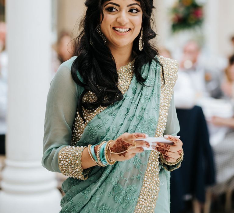 Bridesmaid in green and gold sari