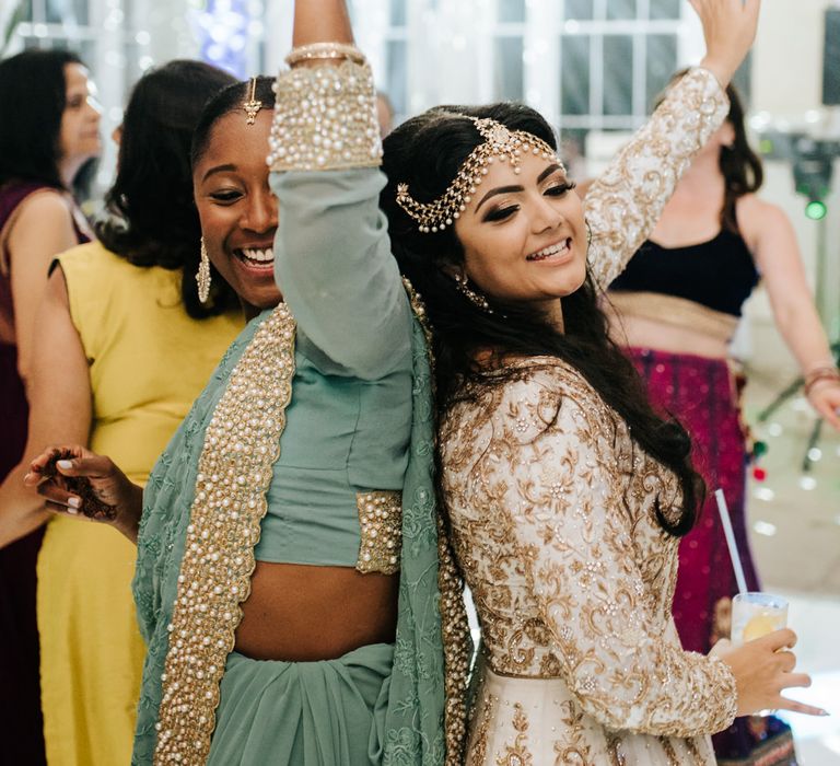 Bride and bridesmaid in Indian inspired dresses