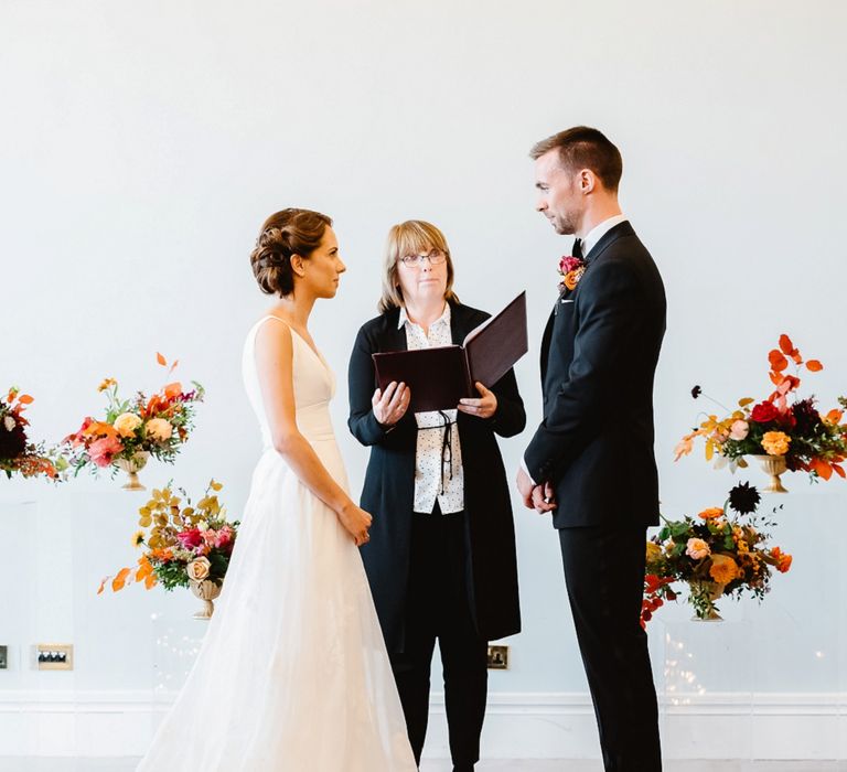 Bride and groom exchanging vows at Carlton House Terrace wedding planned by Always Andri Planner