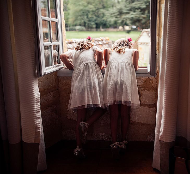 Flower girls peer out of window