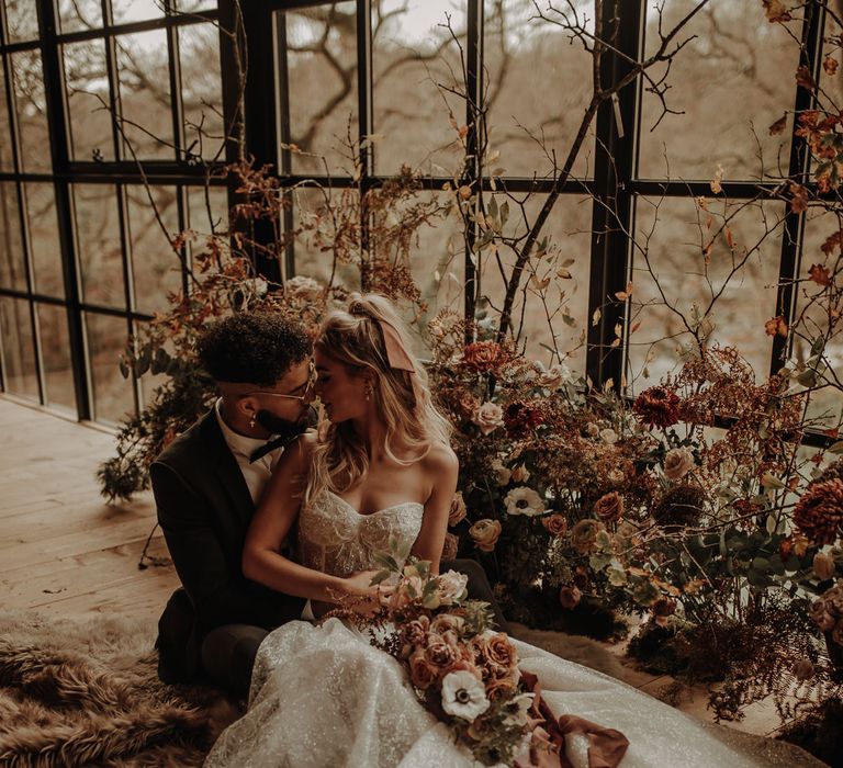 Bride in strapless wedding dress and groom in tuxedo for Christmas wedding inspiration 