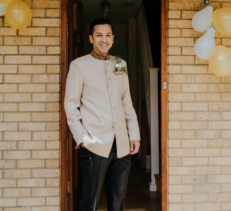 Groom in gold bespoke wedding suit 