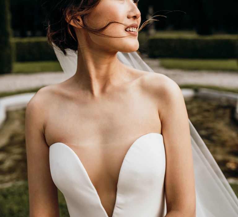 Beautiful Asian bride with natural makeup and strapless wedding dress with sheer element 