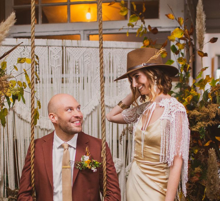 Bride wearing grooms hat