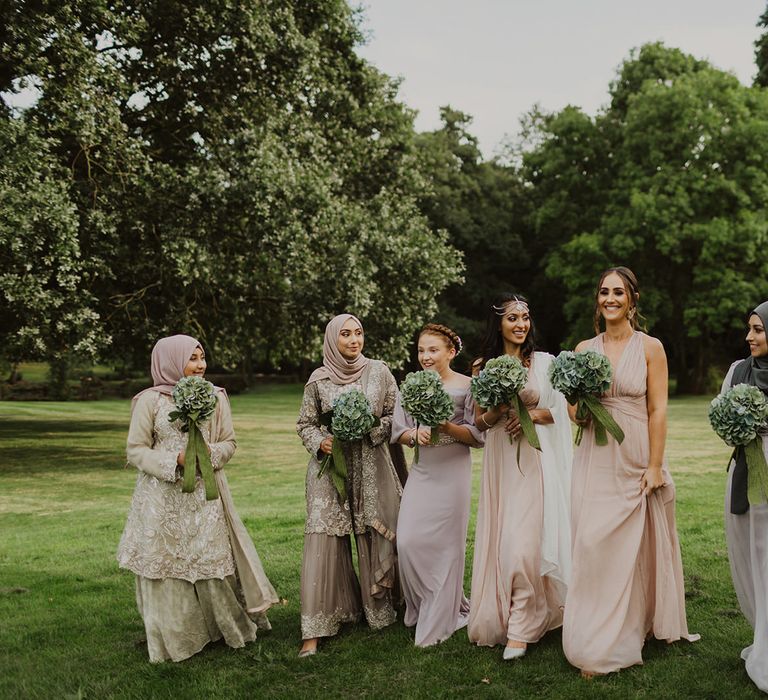 Bridesmaids in pastel dresses and saris'