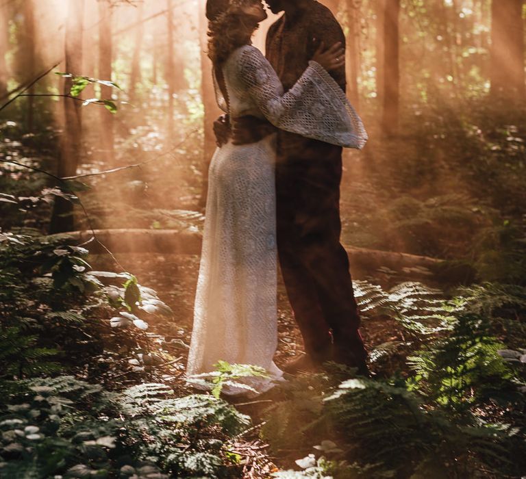 Bride & groom at Longton Wood with sunlight streaming through trees