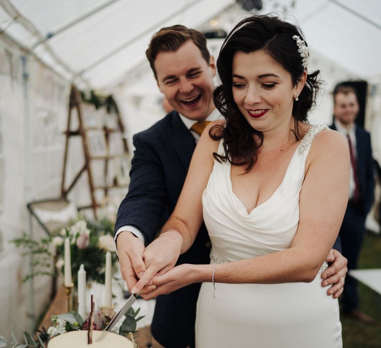 Bride & groom cut their cake at wedding reception 